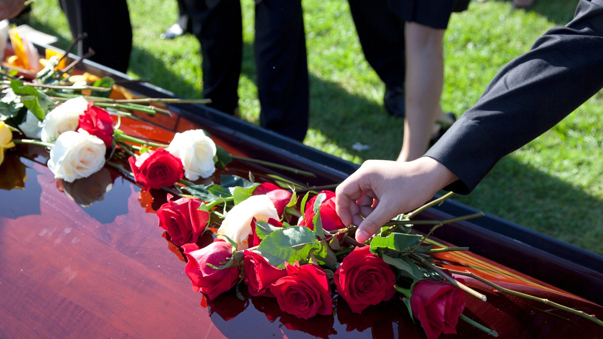 Laying flowers on a casket